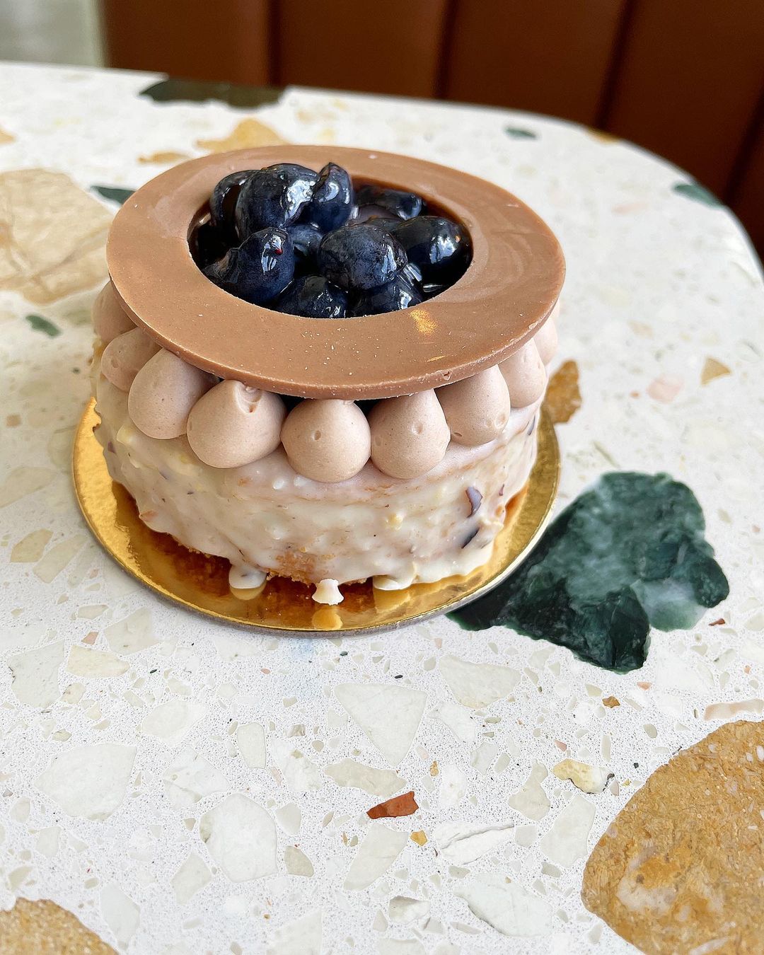 Italian-inspired dessert: cake with blueberries and chocolate topping.