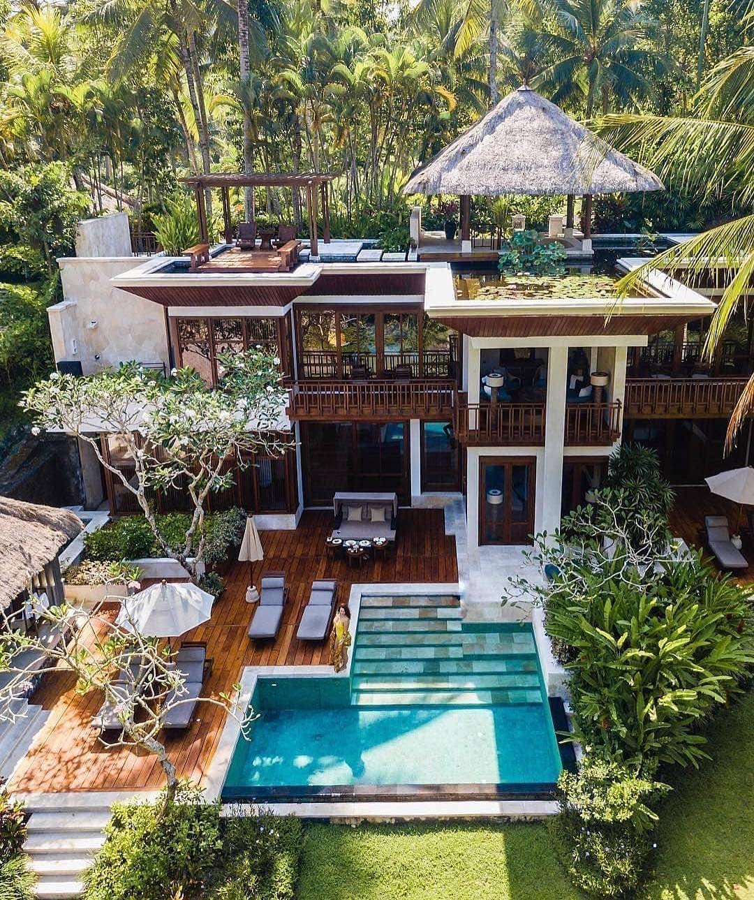A picturesque thatched cottage with a white fence, adorned with colorful flowers, reminiscent of a fairy tale garden.