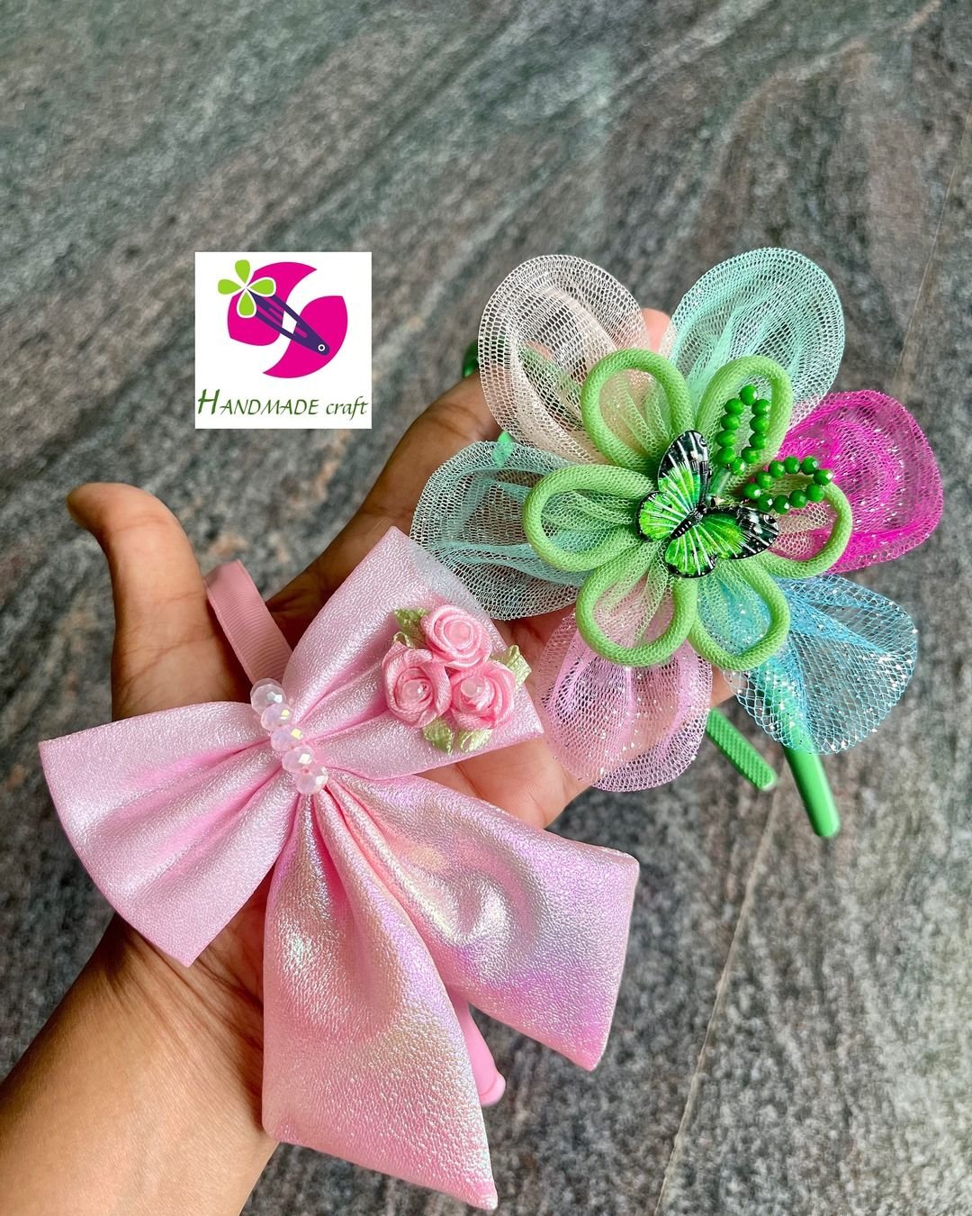 Delicate handmade craft with two small bows and flowers elegantly arranged on a hand.