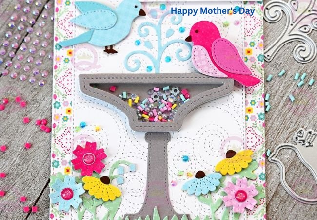 A Mother's Day card featuring colorful birds and flowers.