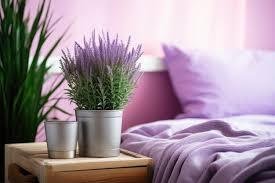  A cozy bed adorned with lavender sheets, accompanied by a plant on a rustic wooden table nearby.
