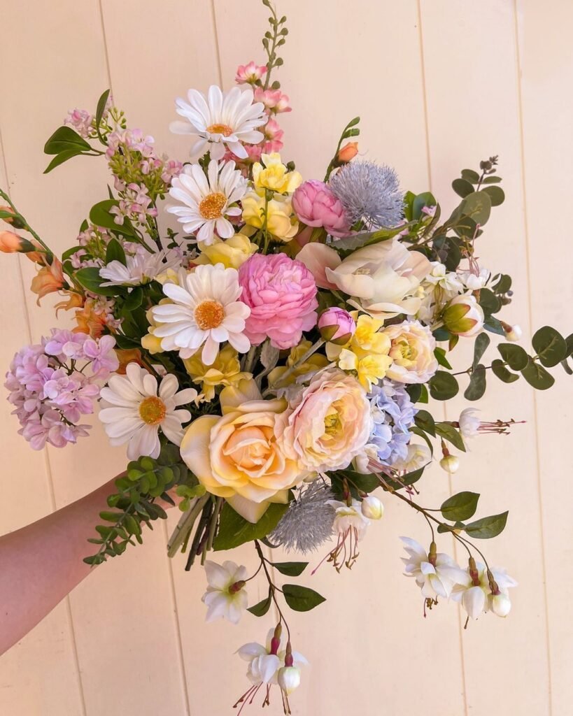 Faux wedding flowers are artificial blooms designed to mimic the look of real flowers, offering durability and lasting beauty for wedding decor.