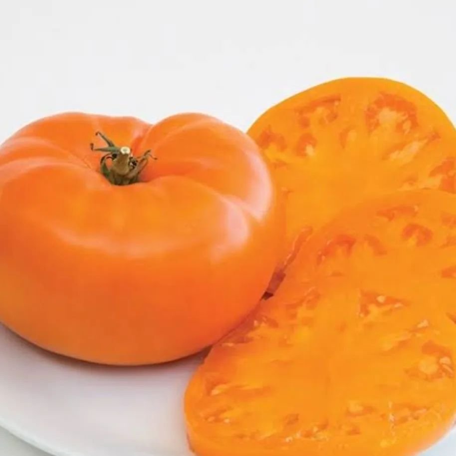 'Amana Orange' is a large, heirloom tomato variety known for its bright orange color, sweet flavor, and meaty texture, thriving in full sun and well-draining soil, and perfect for slicing and fresh salads.