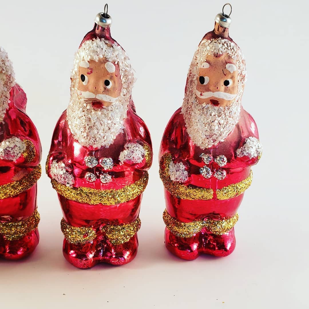 Three glass Christmas ornaments featuring Santa Claus designs, showcasing festive figural artistry for holiday decor